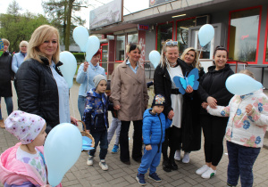 Dzieci wręczają papierowe motylki mieszkańcom Radomska