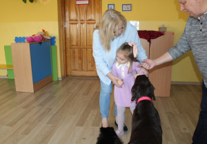 Ania oswaja się z pieskiem w obecności p. Gosi i p. Andrzeja