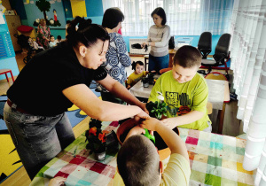 Dzieci przesadzają kwiatki