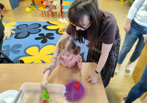 Iza wyławia sitkiem misie.