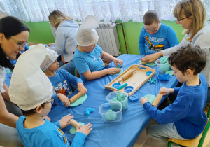 Dzień niebieski - dzieci z grupy I bawią się ciastoliną: wałkują, gniotą, odciskają foremki.
